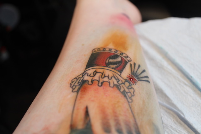 a close of up of a tattoo of a hand with a frilly cuff