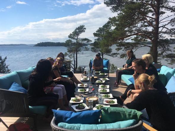 A group of women sitting around a table outside